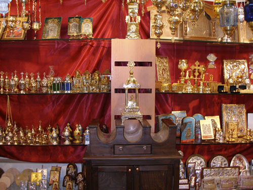 At the front there is a three-slot Candle Case and behind it various Icons, Oil Candles and Chalice Sets (Exhibition Laiki Texni 2009).